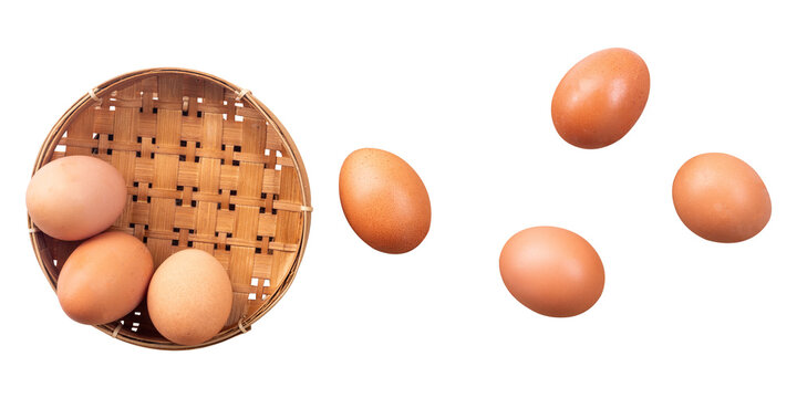 top view of chicken eggs in a wicker basket on white background background