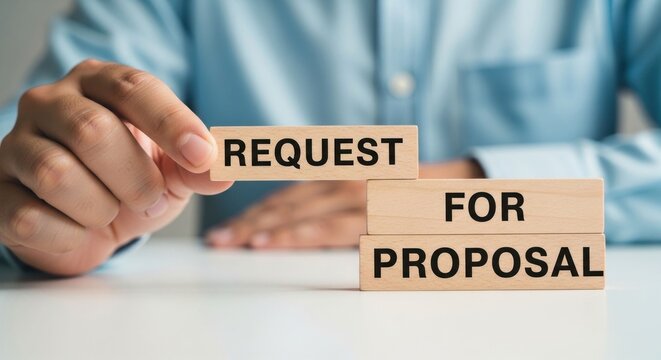 Person holding wooden blocks spelling REQUEST FOR PROPOSAL on a white table representing business communication and project initiation.