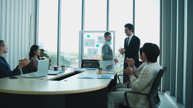 Young, confident company coworkers explain finance and marketing investment analysis, discuss, and brainstorm with multiracial partnership team in meetings and business strategy report presentations.
