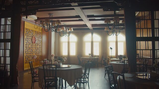 A beautifully decorated restaurant hall for a traditional Chinese engagement ceremony featuring elegant red floral arrangements, gift boxes, and cultural ornaments in a warm, festive atmosphere