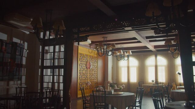 A beautifully decorated restaurant hall for a traditional Chinese engagement ceremony featuring elegant red floral arrangements, gift boxes, and cultural ornaments in a warm, festive atmosphere