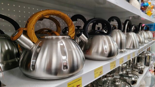 Russia, Samara. February 25, 2025. A large selection of stainless steel teapots on the store shelf. Text in Russian: teapot