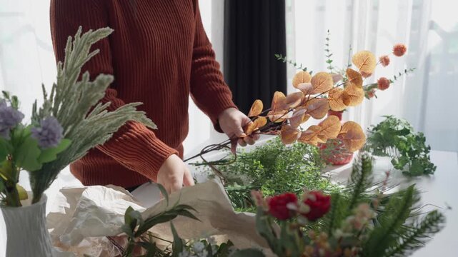 Flower shop owner arranging flowers