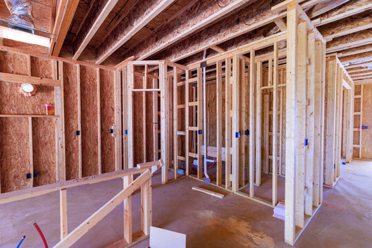 Workers build wooden beams frame walls at construction site where house is taking shape new home