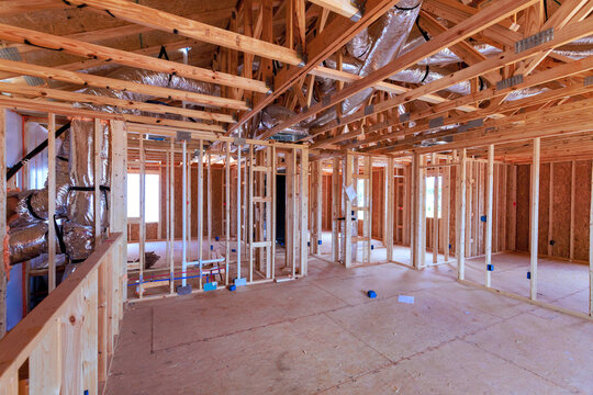 Workers build beams structure of house with wooden frames open spaces