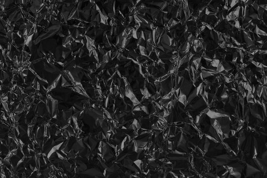 Shiny black grey foil metal texture, abstract wrapping paper for background and design art work.