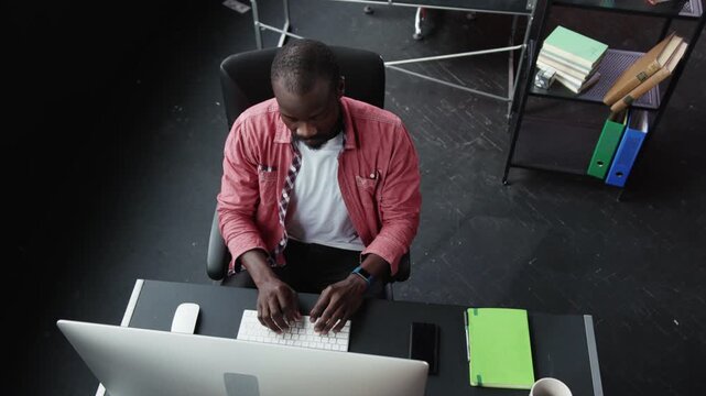 A modern office desk setup that features a computer, chair, and various essential items