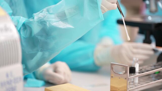 Laboratory test tube swab sample gloved hand medical research clinical scientist hand sample analysis healthcare diagnostics specimen liquid sample lab microscope sterile glove collection.