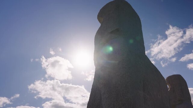 Sun Peaks from Behind Moai Statue, Silhouette of Giant Stone Statue