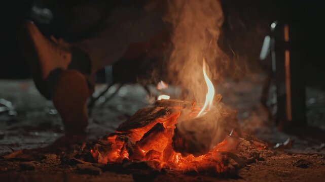 Relaxing acoustic sounds surround crackling flames. Calm melodies drift through warm evening around fiery embers. Gentle guitar harmonies set peaceful mood beside burning flames and glowing coals