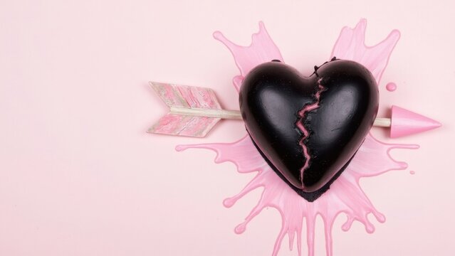 Chocolate heart with pink arrow and dripping icing