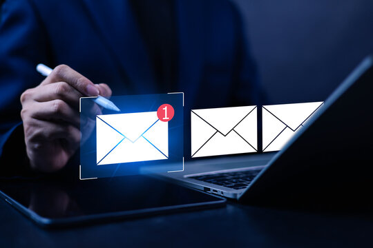 Business professional using tablet and laptop with email notification interface, digital communication concept, inbox message alert, online marketing, customer engagement, modern business technology
