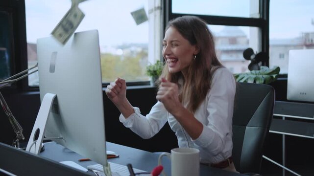 A professional woman working on her computer in a modern, creative, and productive office