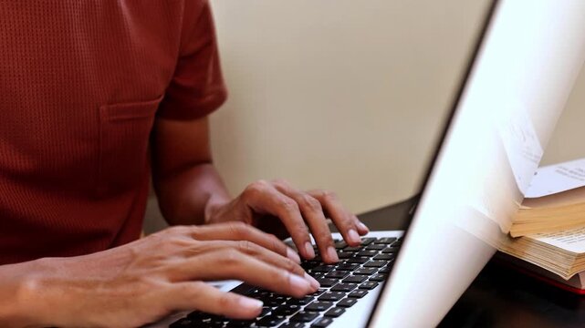 Close-up of hands typing on a laptop keyboard, capturing the motion and detail of everyday digital work. This scene represents productivity, communication, online activity, and modern technology use.