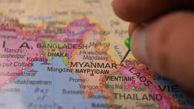 Hand Pointing Myanmar with Green Pin on World Map 4K 60fps Close-Up