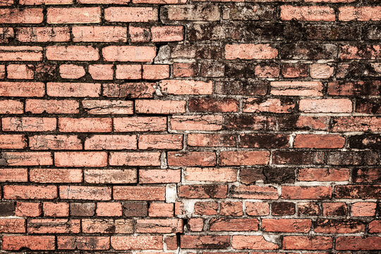 Broken bricks wall background texture. Broken bricks brickwall patterned surface. Broken bricks masonry brickwork structure. Broken bricks grunge rubble texture.