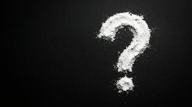 White powder grain question mark symbol on black surface for mystery and inquiry concept with question, background