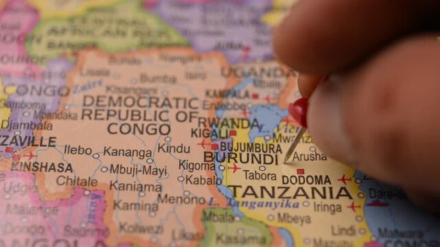 Hand Pointing Burundi with Red Pin on World Map 4K 60fps Close-Up Shot