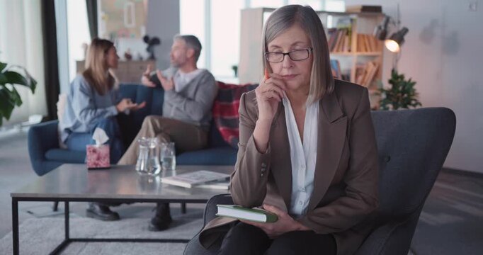 Family Psychologist Mature Female Shaking Head Negatively while Her Patients Married Couple Arguing. Health, Relationships, Family Problems.