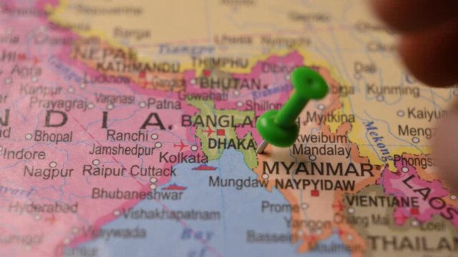 Hand Pointing Dhaka Bangladesh with Green Pin on World Map 4K 60fps Close-Up