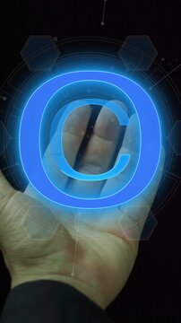 Copyright symbol for author rights and patented intellectual property. Copyleft trademark license. Copyright or patent concept. Businessman showing glowing neon line of copyright icon.