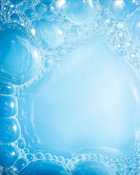 soap foam background that creates a soft blue hue, made of many transparent bubbles of different sizes, used as a background image for web design or presentations.