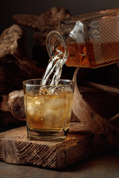 Glass of whiskey on a old wooden board.