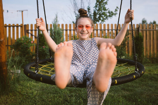 happy child on swing in village of Countryside during summer holidays
