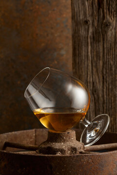 Cognac in snifter on old rusty wheel.