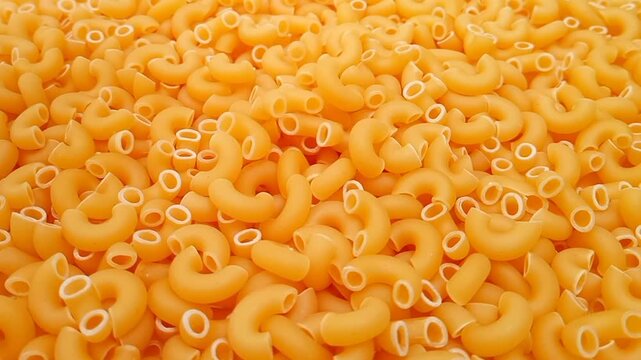 Elbow Macaroni Pasta Dropping on Uncooked Elbow Macaroni Ingredient, Food Background