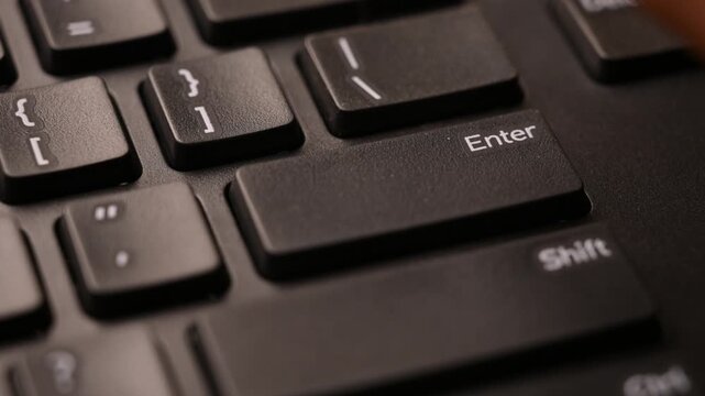 Close Up Keyboard Action of Man Using Enter Key for Data Submission on Computer 