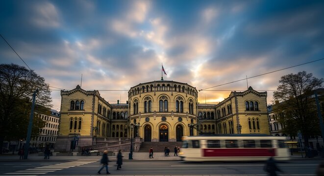 Norwegian Parliament (Stortinget) building in Oslo at sunset with motion blur of a tram and pedestrians.