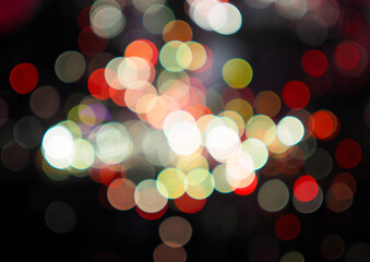 Obraz premium Colorful abstract bokeh lights on black background for celebration and Christmas