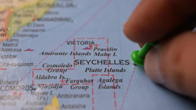 Close-Up World Map Shot Featuring Green Pin Highlighting Seychelles Pointed by Hand 4K 60fps
