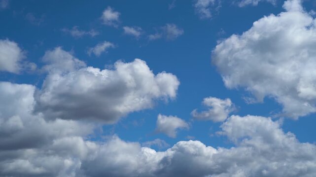 A calm blue sky with slowly moving clouds creates a peaceful atmosphere.