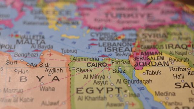 Close-Up World Map Shot Featuring Blue Pin Highlighting Cairo Egypt Pointed by Hand 4K 60fps