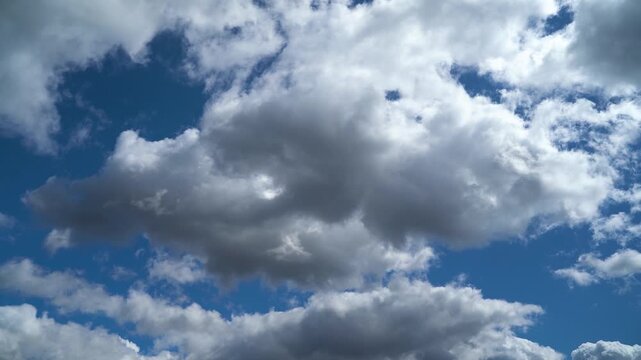 White clouds slowly drift across a bright blue sky, creating a sense of calm and freedom.