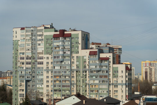 Large high apartment building in the style of eclecticism with a dilapidated facade