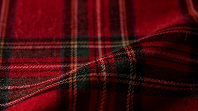 Cozy vibrant red plaid fabric gently folding and flowing close up textile texture background