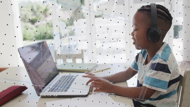 Child placing hands on laptop, causing dotted grid and line-graph overlays to appear while learning
