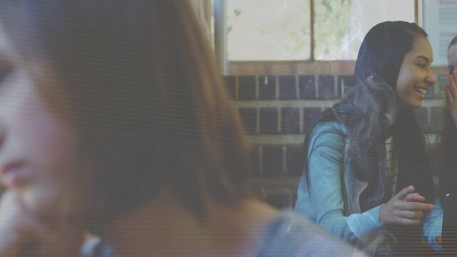 Teen girls sharing phone joke on school stairs, animated focus shifting to pensive child by window