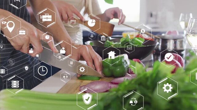 Vertical video: Slicing as hands meet, pair in aprons making salad with knife in kitchen, AR icons