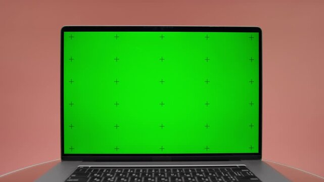 Laptop With Green Screen On Pink Background