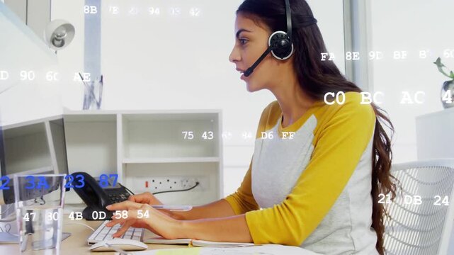 Support rep taking call, typing, talking, glancing notes, blue-white data flowing over screen