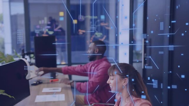 Man sitting prompts team adjusting monitor and headset, tech overlay flowing over desks for work