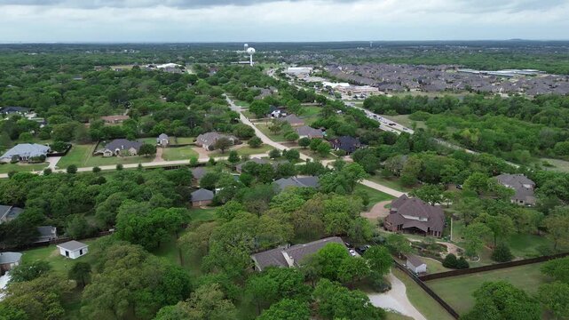 Green belt residential corridor along FM 407 winding roads, wooded buffers, expanding Copper Canyon neighborhoods toward regional connectors. Rooflines, open lawns, dense surrounding greenery, TX