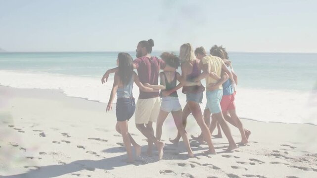 Group of seven walking linked along beach, scanlines fading, revealing footprints for travel ads