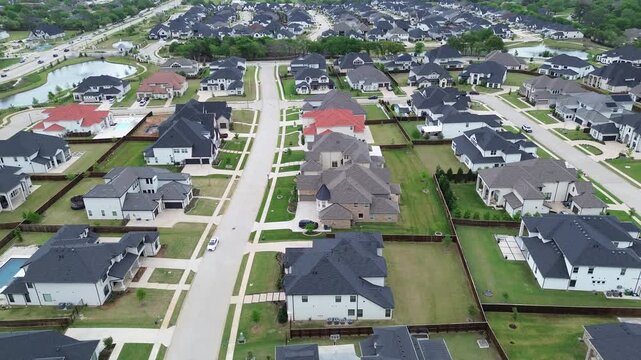 Expanding subdivision grid south of FM 407 extends toward wooded drainage corridors marking Copper Canyon shift to denser suburban form. Varied roof colors, clean street lines, Flower Mound, Texas