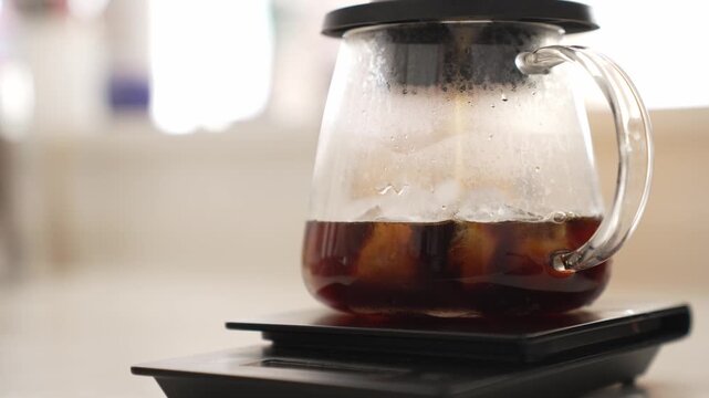 Glass Teapot with Iced Cold Brew Coffee on Digital Scale &ndash; Cafe Style Kitchen Video 4K