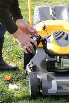 Pouring Oil Into Lawn Mower and Checking Oil Level &ndash; Small Engine Maintenance Close Up - Countryside Living and Outdoor Chores Lifestyle